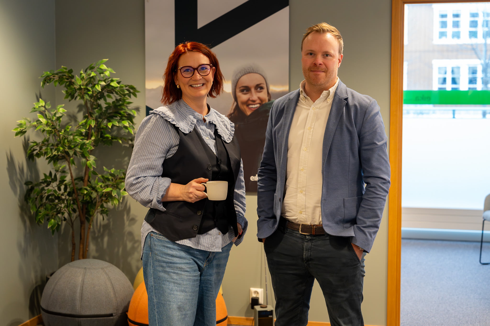 to ansatte står i miljø og ser mot kamera